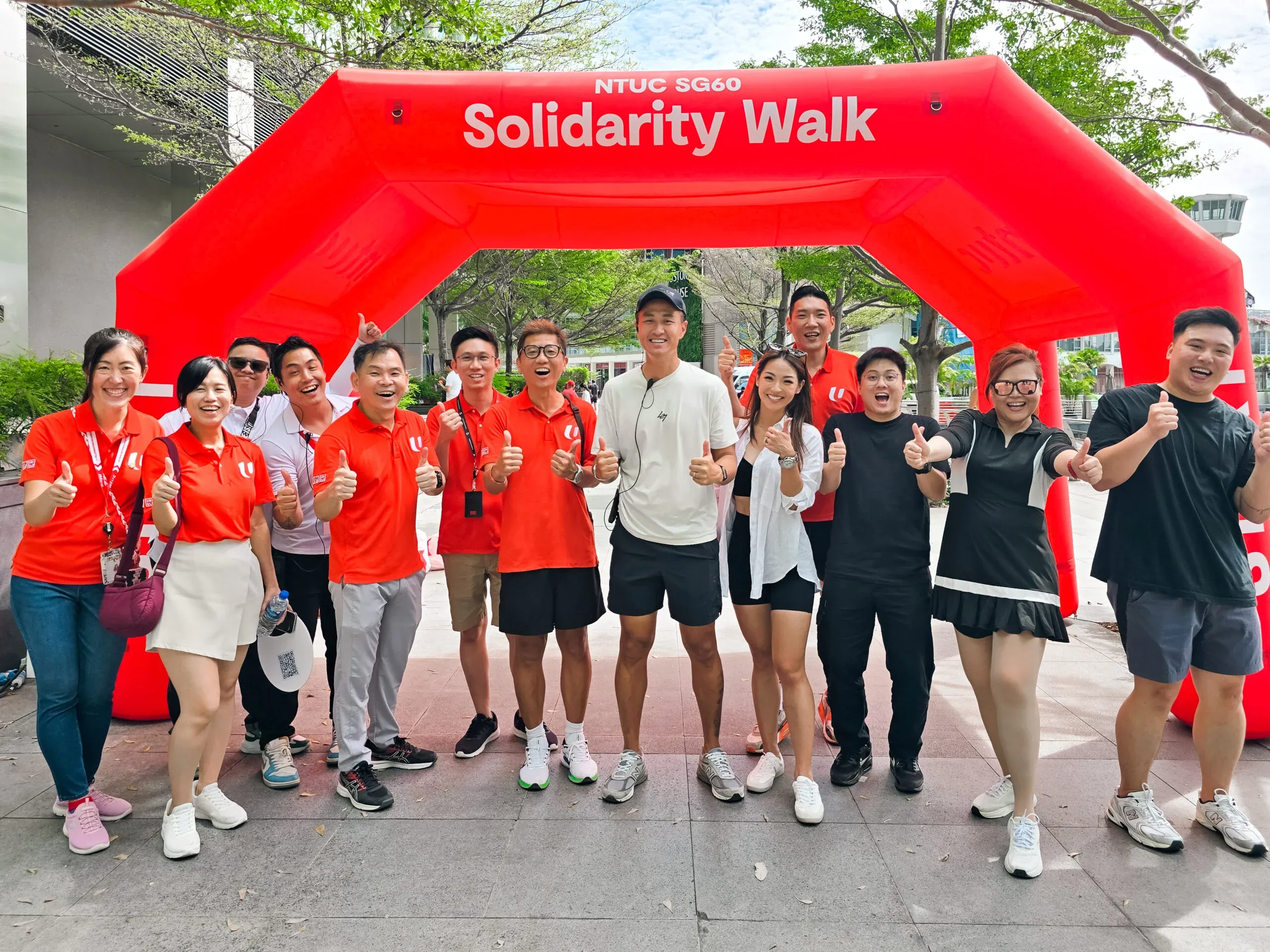 Large-scale charity walk event with volunteers and participants along Singapore route